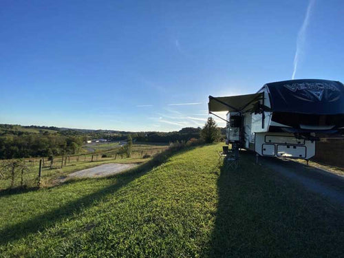 An RV at sunrise in a pasture