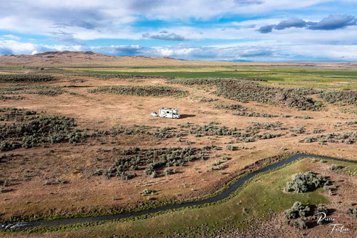 An RV parked in an open field